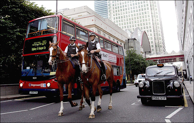 Police patrol London's Canary Wharf as part of a massive show of force in the British capital, August 4, 2005.